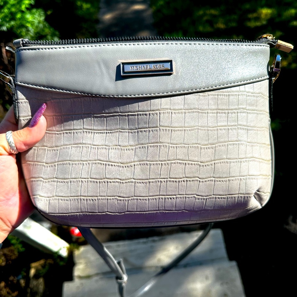 Small Michael Kors gray crossbody purse with zipper pockets and suede lining